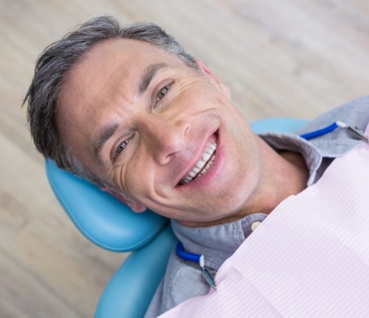 Smiling man looking up in dental chair