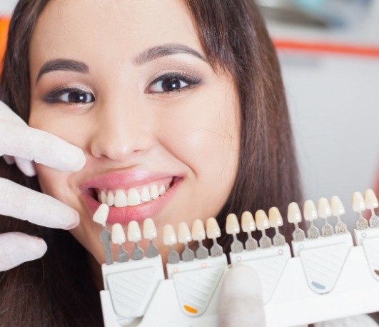 Smiling woman being fitted for dental veneers
