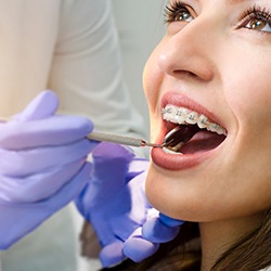 Happy patient with professional braces at checkup appointment
