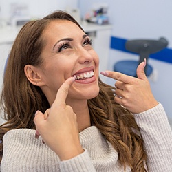 Woman with straight teeth, happy she could afford braces