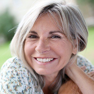older woman smiling outside