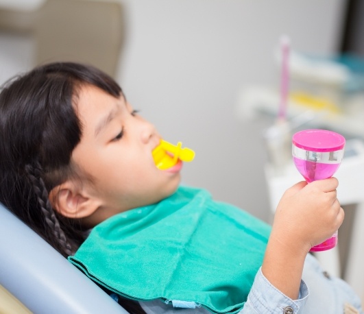 Child having fluoride applied to their teeth