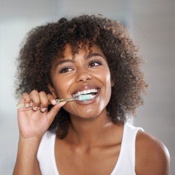 woman brushing teeth