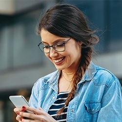 woman with glasses on tablet