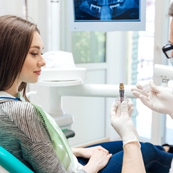 dentist and patient discussing dental implant placement procedure