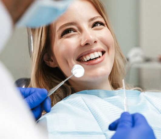 lady smiles at dentists