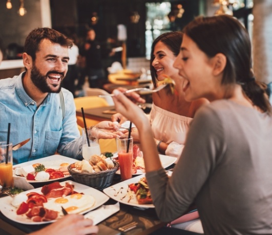 Four adults eating at a restaurant