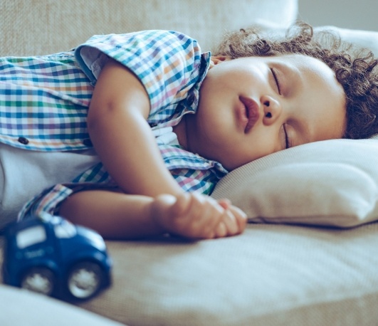 Young boy sleeping on his side