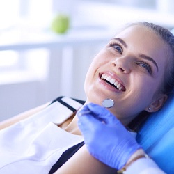 Woman in a dental chair during routine appointment.
