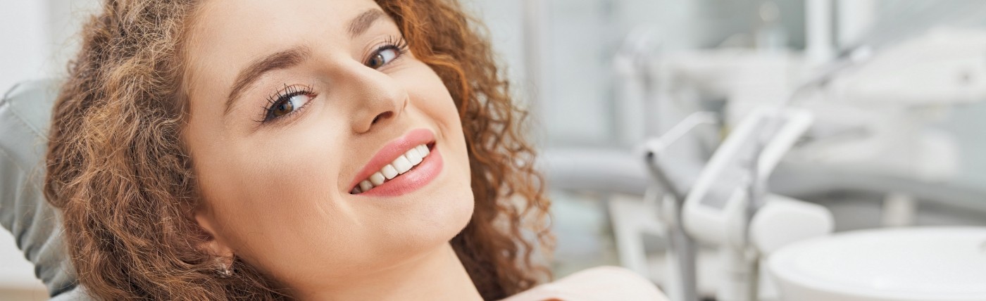 Smiling woman in dental chair visiting her Humana dentist in Waco