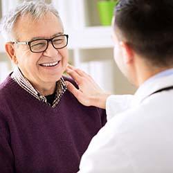 Patient smiling at his Waco implant dentist