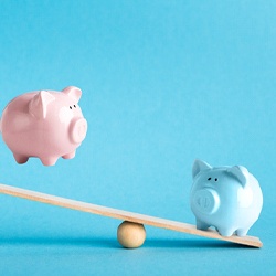 Piggy banks on balance scale