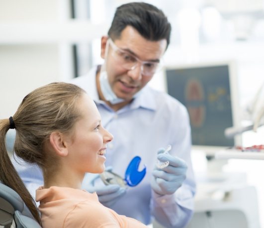 Dentist fitting a patient with Invisalign