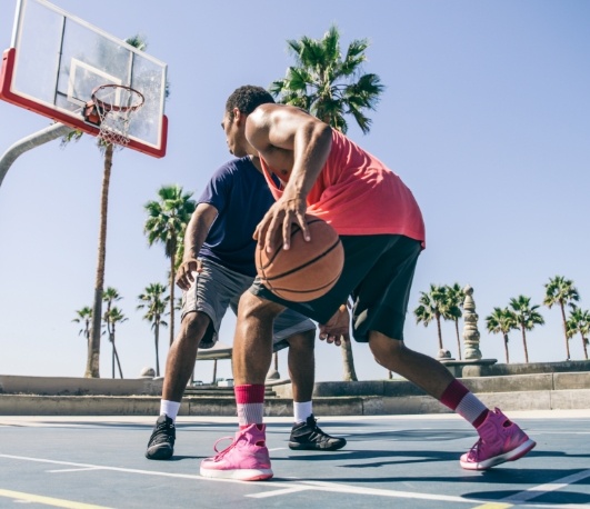 Two men playing basketball