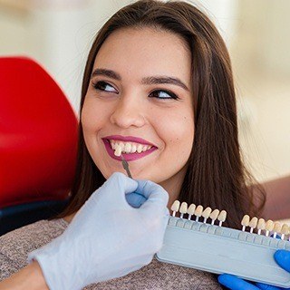 testing veneer to woman's smile