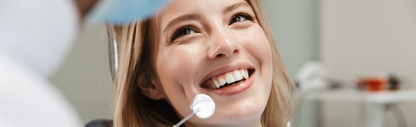 Woman smiling at her dentist during a preventive dentistry checkup in Waco