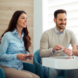 a couple discussing dental treatment with a dentist in Waco