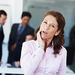 woman in pink shirt in pain