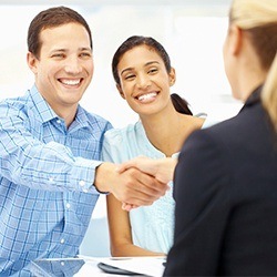 man shaking hands with front desk worker