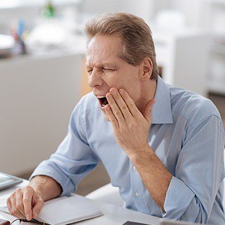 man opening mouth and in pain