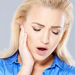 woman holding jaw