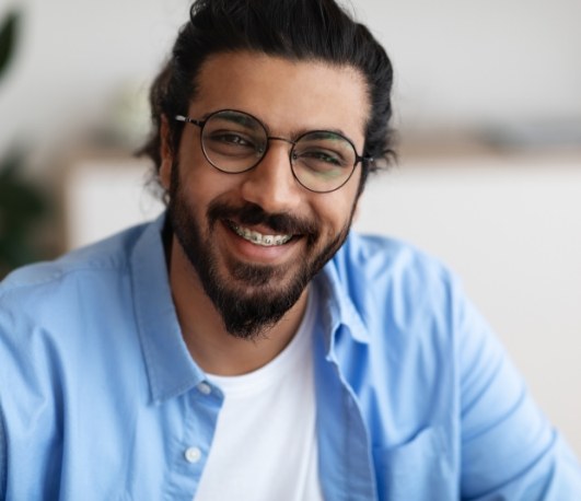 Adult man smiling with traditional braces