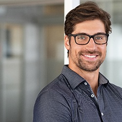 Man with glasses smiling with veneers in Waco, TX