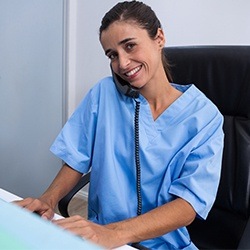 woman in scrubs talking on phone