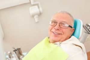 man smiling sitting in dental chair