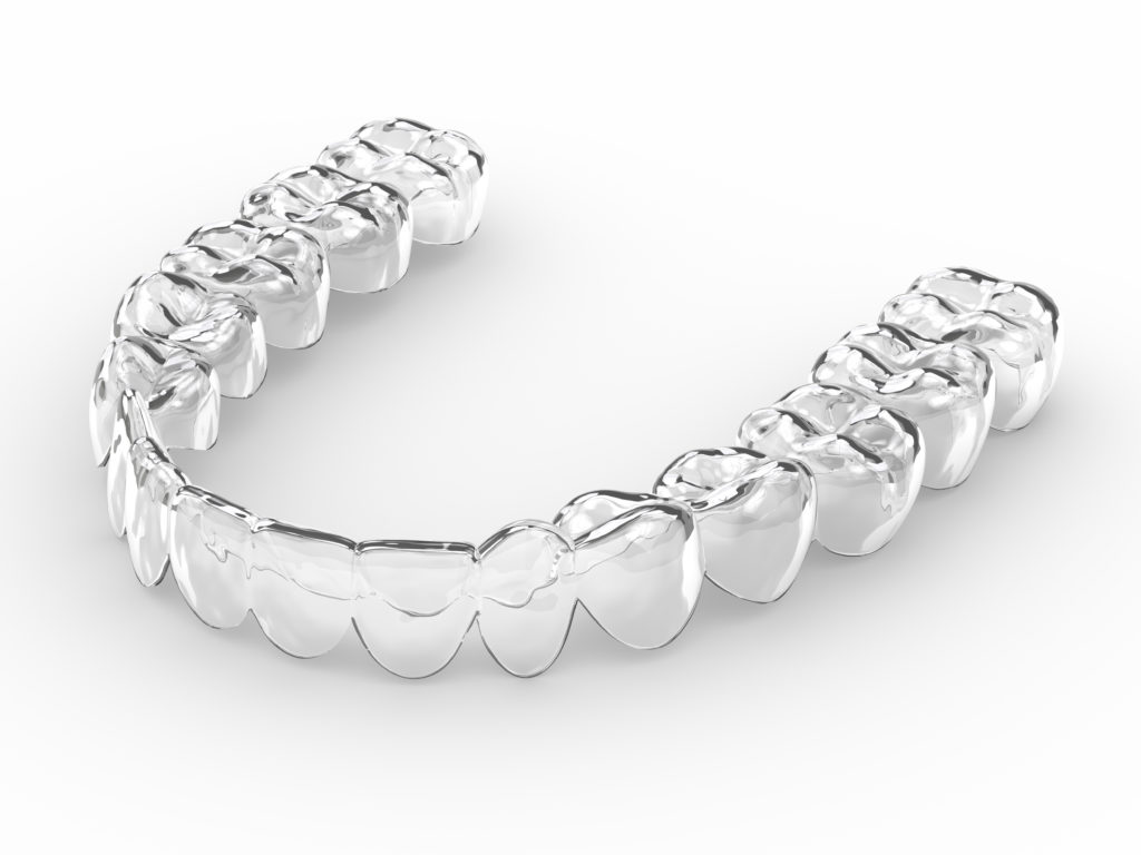 Close-up of an Invisalign aligner on white background