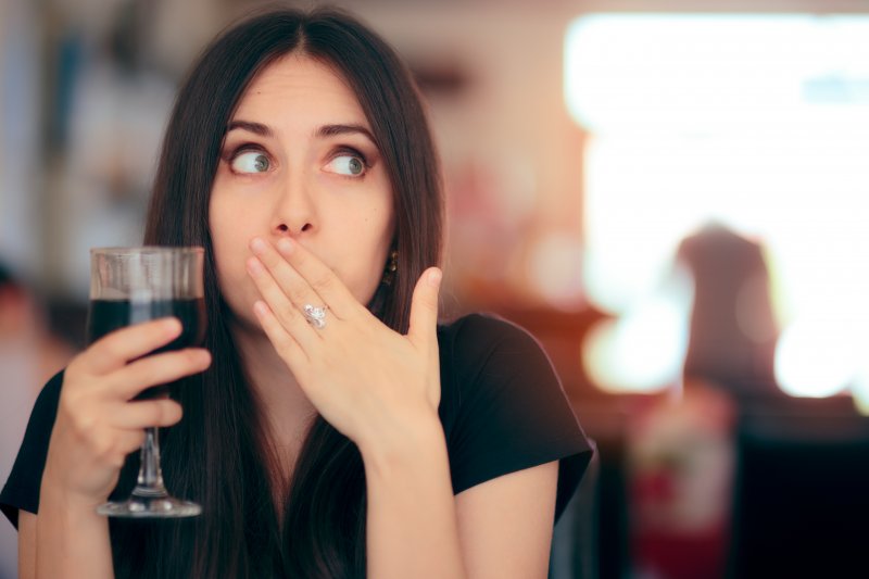 woman reacting after drinking wine