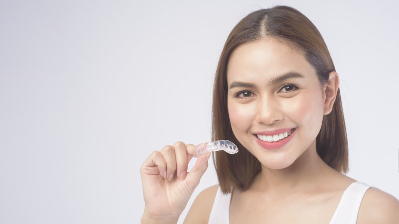 woman in Waco holding Invisalign