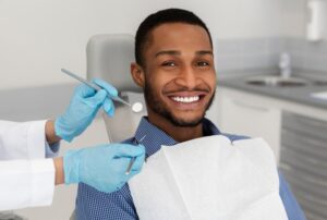 Man smiling after getting his final veneers placed