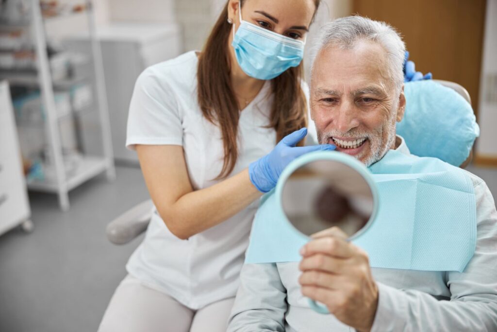 A man looking at his smile after getting All-on-4
